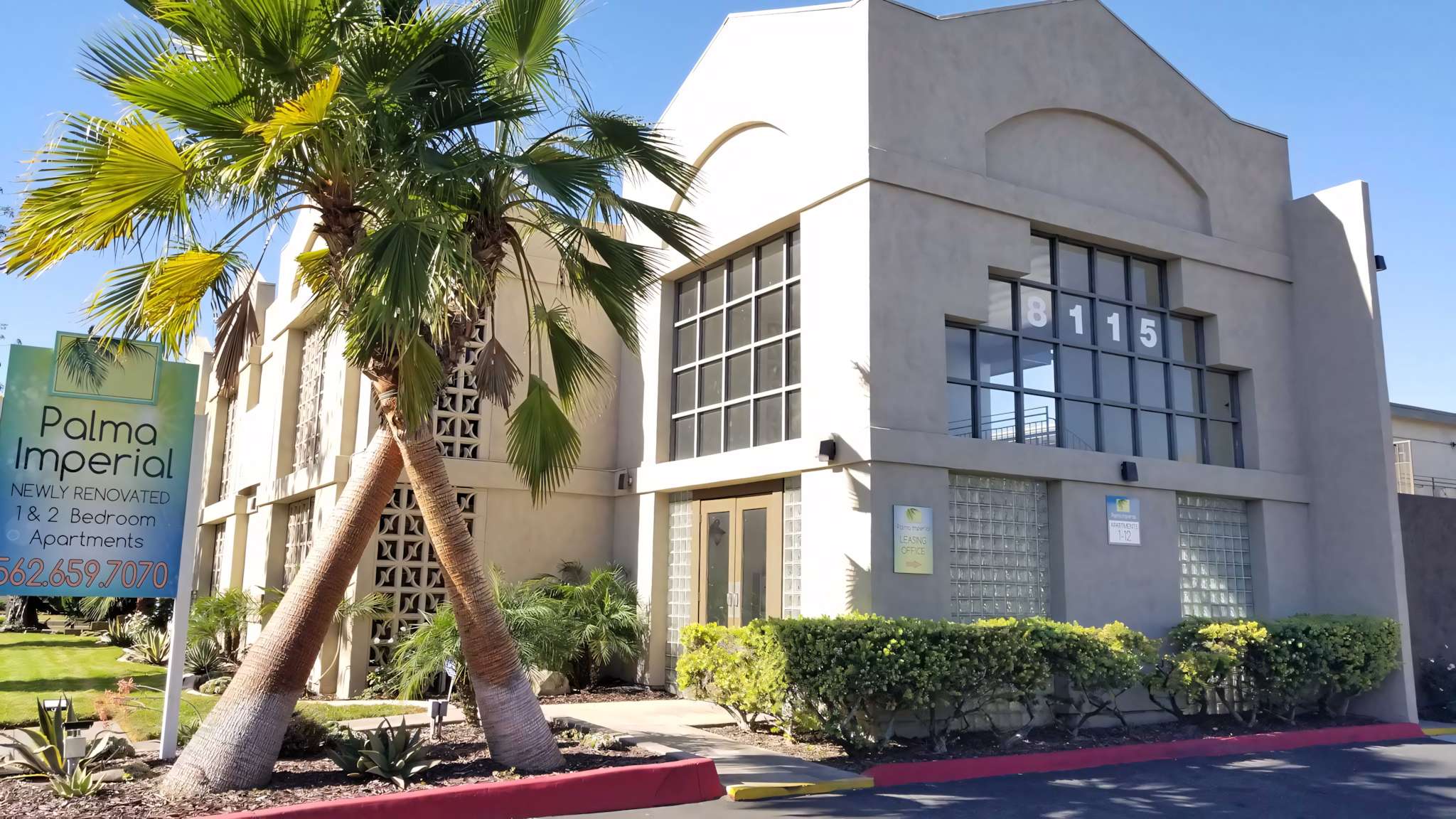 Palma Imperial leasing office entrance and palm tree landscaping
