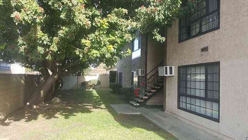 gated courtyard with mature shade trees