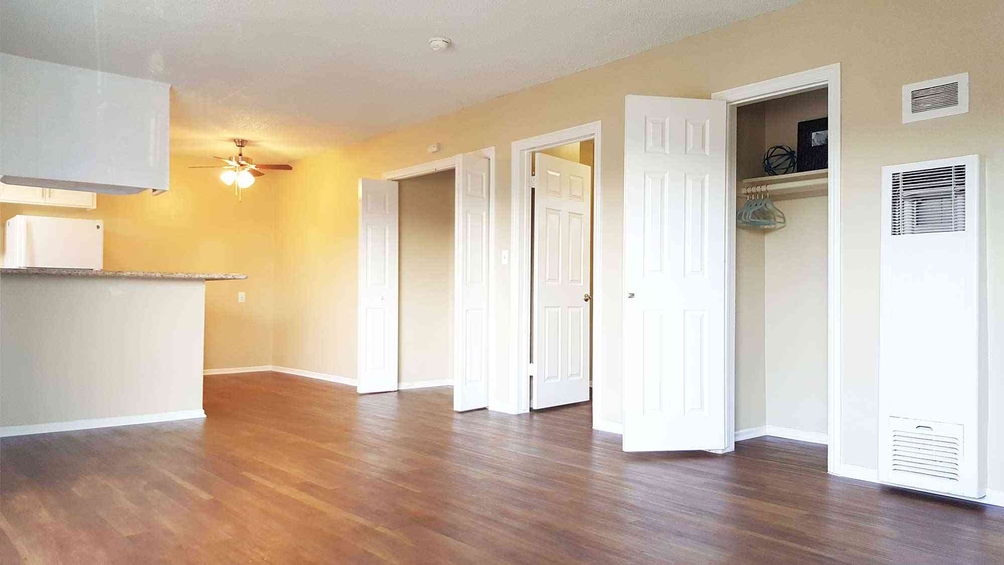 bright living room with hallway closet storage