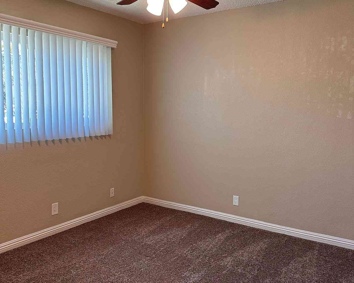 cozy bedroom with plush carpeting and ceiling fan