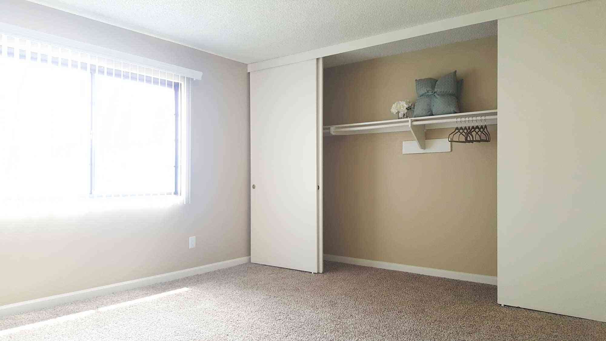 bright bedroom featuring sliding closet doors